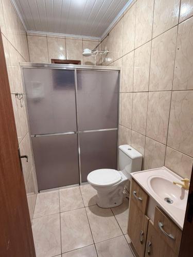 a bathroom with a shower and a toilet and a sink at Pousada São Gabriel - M&M in São Gabriel