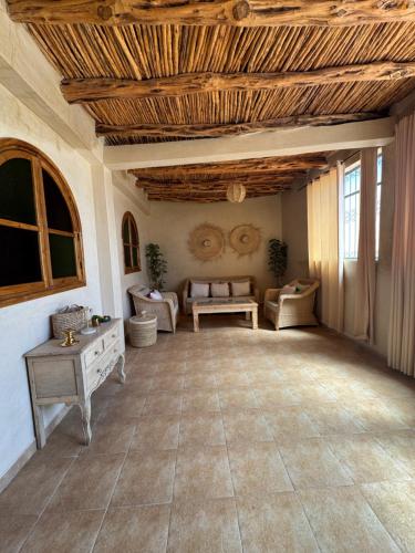 a large living room with a wooden ceiling at Your Peaceful Spot in Essaouira