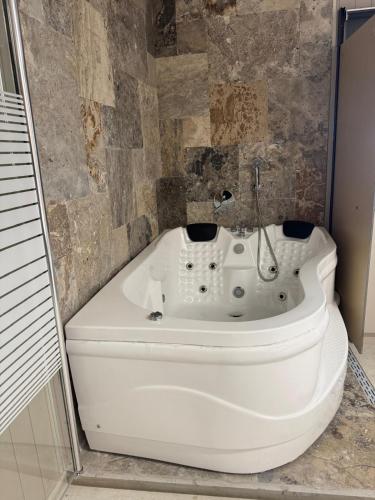 a white bath tub sitting in a bathroom at רויאל דליה in Dāliyat el Karmil