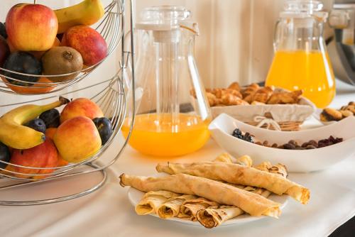 a table with a bunch of fruit and other foods at Magus Hotel in Baia Mare