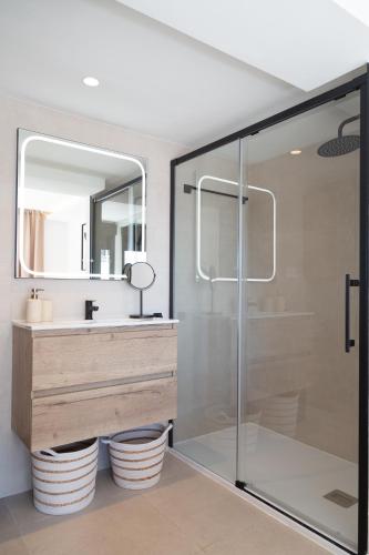 a bathroom with a glass shower and a sink at Boutique Apartment with Sun Terrace & Sea Views in Torremolinos