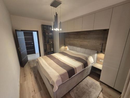 a bedroom with a large bed in a room at Apartman Nina in Donovaly