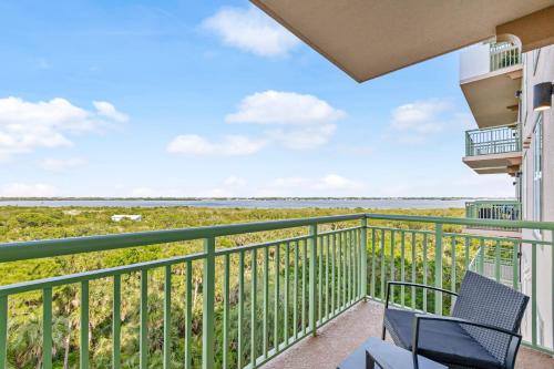 a balcony with two chairs and a view of the ocean at RIVER FLY IN The Cocoa Launchpad Lookout View RFI-705 in Audubon