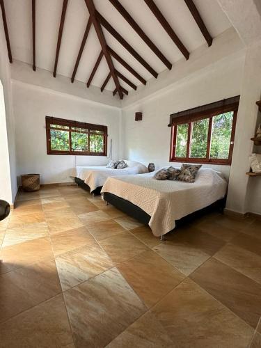 a large room with two beds in it at Finca La Verbena in San Jerónimo
