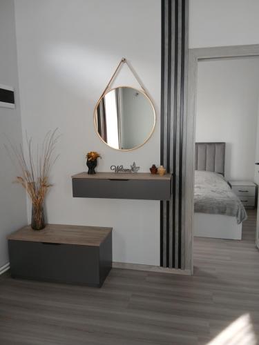 a bedroom with a mirror on a wall at Elite Guest House in Goris