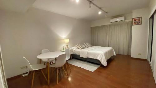 Sinclair 3044 في بوينس آيرس: غرفة نوم بها سرير وطاولة وكراسي