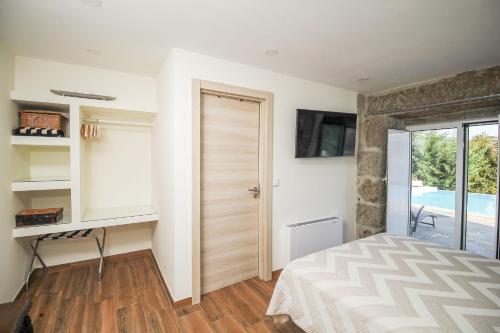 a bedroom with a bed and a desk and a window at Bosque da Fantasia in Baião