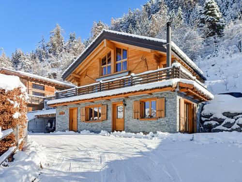 a log cabin in the snow with snow covered trees at FeWo im Chalet Schneeflöckli in La Tzoumaz