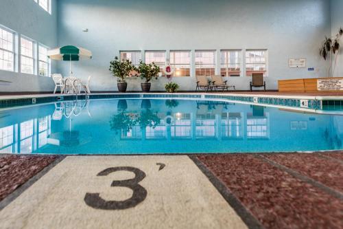 a large swimming pool in a building with the number three at Angel Inn - Central in Branson
