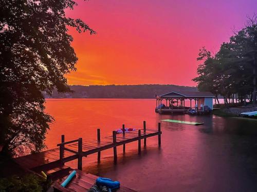 a dock on a lake with a sunset in the background at Gorgeous Lakefront Escape - New Renovations in Mineral