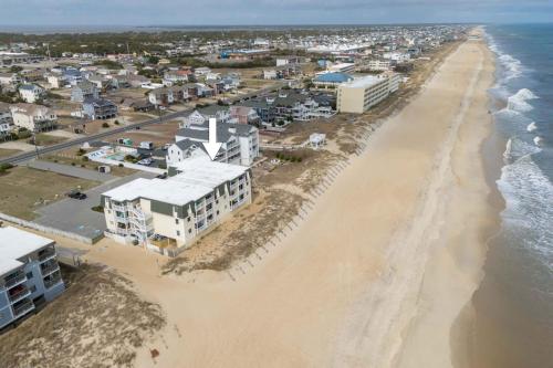 an aerial view of the beach and buildings at Beachfront Condo with Ocean Views and Pool Access in Croatan Shores