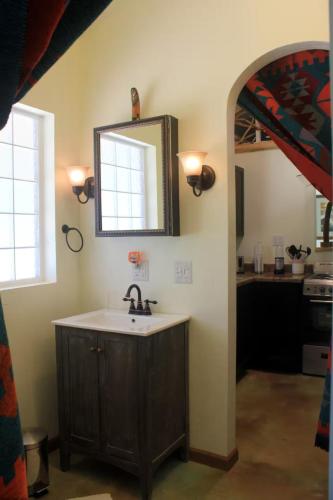 a bathroom with a sink and a mirror on the wall at The Barn House in Eureka Springs