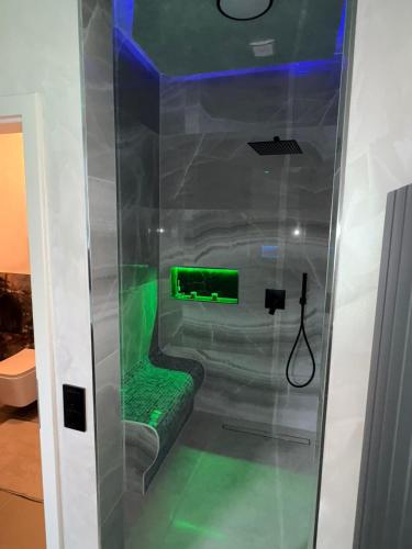 a room with a shower with a green seat at Aura Spa Herne Premium in Herne