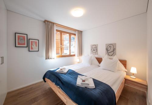 a bedroom with a bed with two plates on it at Panoramapark Soleil Chalet B in Wengen