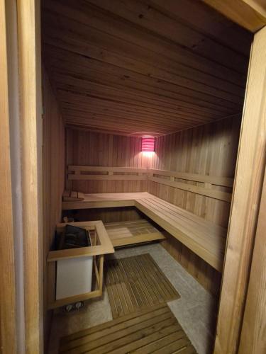 a small wooden sauna with a pink light in it at Gyékény Pihenő in Szarvas