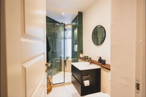 a bathroom with a sink and a shower at Luxury apartment with sea view - 3 rooms in Hillerød