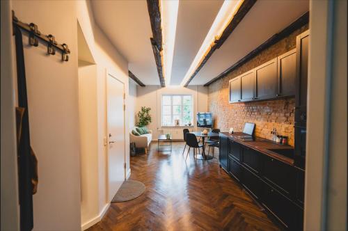 an open kitchen and living room with a brick wall at Luxury apartment with sea view - 3 rooms in Hillerød