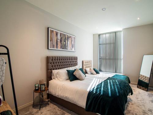 a bedroom with a bed and a large window at Modern 1 bed Apartment in Central Leeds in Central Station
