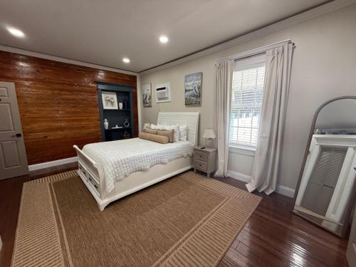 a bedroom with a white bed and a window at The Elizabeth Suite in Key West