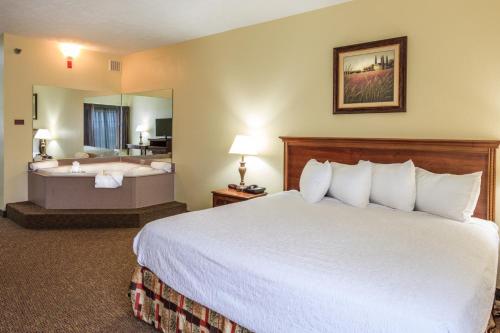 A bed or beds in a room at Branson Towers Hotel