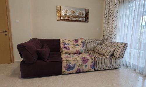 un divano in soggiorno accanto a una finestra di Elia Sunset a Lagomandra