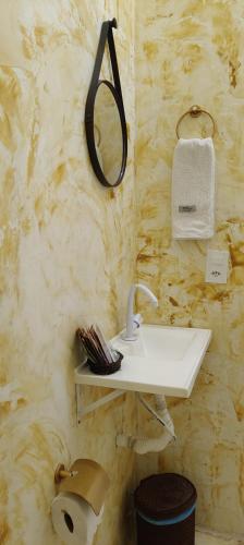 a bathroom with a sink and a mirror on the wall at Chalé Com Piscina Privativa in Fortim