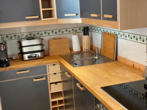a kitchen with a sink and a counter top at 2,5 Zimmer Wohnung mit Bergblick in Engadin in Zuoz