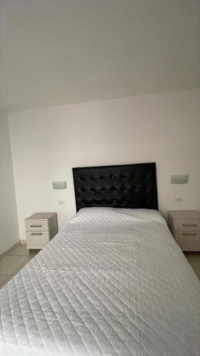 En eller flere senge i et værelse på Departamento hasta 4 personas Villa Dolores