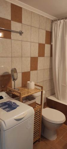a bathroom with a toilet and a sink and a tub at Parastaseis City Apartment Central in Patra
