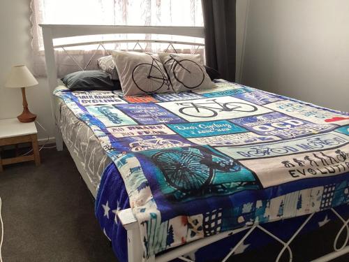 a bed with a quilt on it in a bedroom at Funski Lodge sleeps 10 Where Adventure Begins in Taumarunui