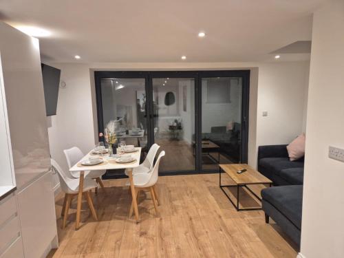a living room with a table and a couch at 2Bed Ground Floor Apartment With Private Garden in London