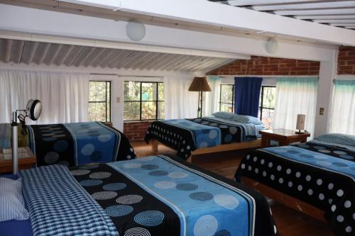 Postel nebo postele na pokoji v ubytování Casa Xitle