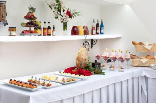 a table with appetizers and wine glasses and food at Boutique Hotel Budzak in Ždiar