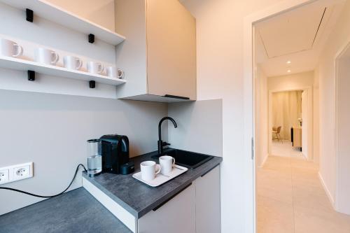 a kitchen with a counter with a coffee maker at saGo Airporthouse in Düsseldorf