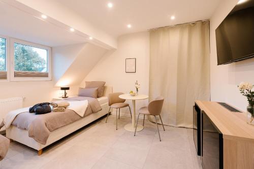 a bedroom with a bed and a table at saGo Airporthouse in Düsseldorf