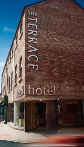 a hotel sign on the side of a brick building at The Terrace Hotel in Magherafelt