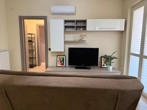 a living room with a tv on a table at Rama house in Caserta