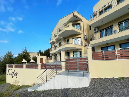 a large apartment building with stairs in front of it at Favelas Luxury Apartments in Kavala