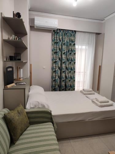 a bedroom with a large bed and a window at Parastaseis Central Studio Georges Sq in Patra