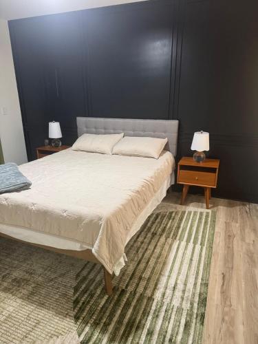 a bedroom with a large bed and two night stands at Modern Nature Escape in Sparta