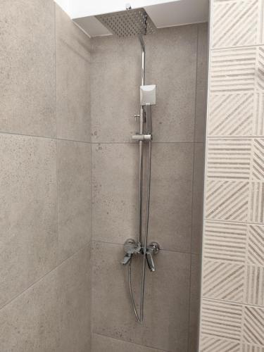 a shower in a bathroom with a glass door at Parastaseis Central Studio Georges Sq in Patra