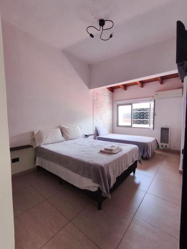 a bedroom with two beds and a window at Aisha Alojamiento in Salta