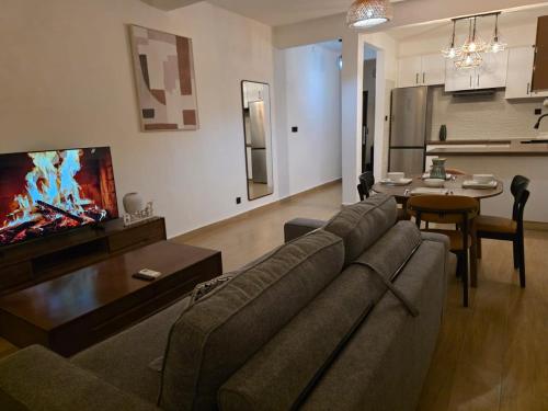 a living room with a couch and a table at T2 moderne en bord de mer 