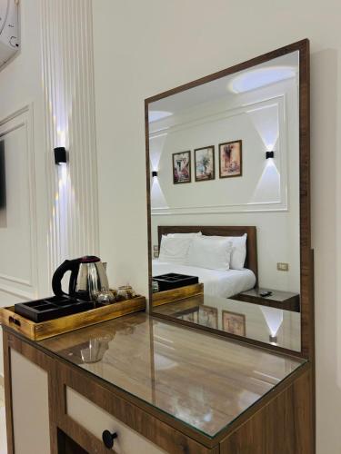 a bedroom with a bed and a large mirror at Nile Castle in Luxor