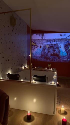 a bathroom with a large mirror on the wall at L Antre du Désir in Saint-Léonard