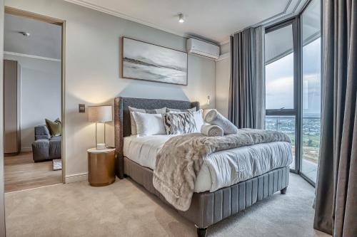 a bedroom with a bed and a large window at Bella Vista at Ellipse in Midrand