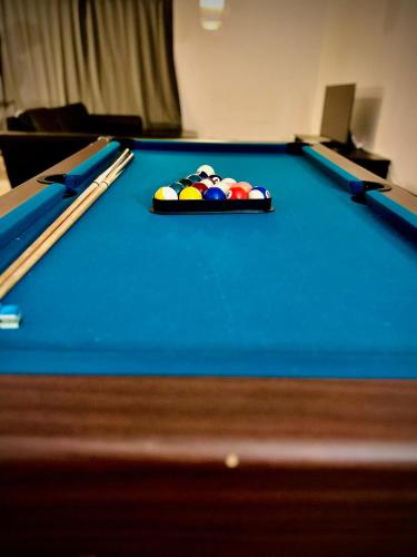 a pool table with cue balls on top of it at Family Villa, 2 min lalandia, Beach & Ferry, free parking, Fastest Fiber Internet in Rødby
