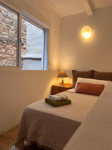 a bedroom with a bed with a window at Restored house near Valencia in Simat de Valldigna