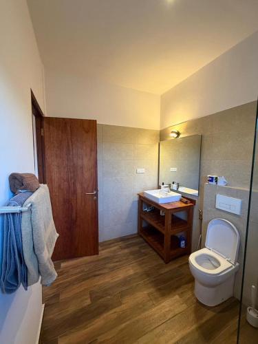 a bathroom with a toilet and a sink at Secret Garden Villa in Kendwa