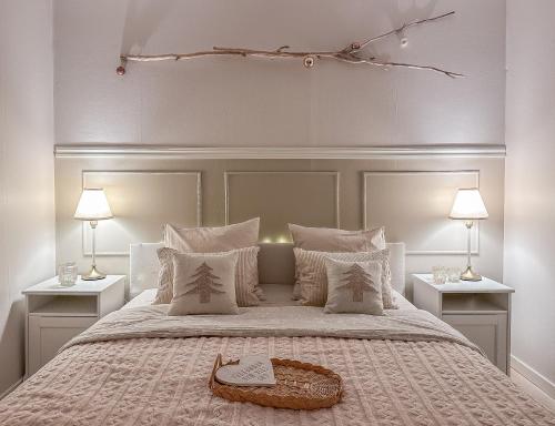 a bedroom with a large bed with two lamps at Aurora House in Karungi